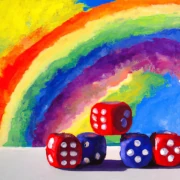 A painting of five Yahtzee dice with a rainbow in the background